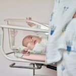 how to put a newborn in a bassinet without waking them