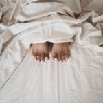 why do i curl my toes when i sleep