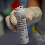 how to get spray adhesive off skin safely